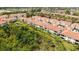 Beautiful aerial view of a condo building with tile roof, balcony, and lush surroundings at 301 Ravinia Cir # 301B2, Venice, FL 34292