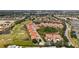 An aerial view displays a condo community with golf course, ponds and lush landscaping at 301 Ravinia Cir # 301B2, Venice, FL 34292