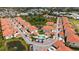 Aerial view of neighborhood featuring well-maintained homes with red-tiled roofs and a community pool at 301 Ravinia Cir # 301B2, Venice, FL 34292