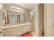 Bathroom with double sinks, vanity and a glass enclosed shower with tile surround at 301 Ravinia Cir # 301B2, Venice, FL 34292
