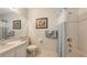 Well-lit bathroom featuring a shower-tub, single sink vanity, and neutral tile flooring at 301 Ravinia Cir # 301B2, Venice, FL 34292