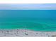 A sunny beach scene, full of people relaxing by the teal ocean waters and white sand at 301 Ravinia Cir # 301B2, Venice, FL 34292