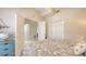Bedroom featuring paisley bedding, neutral walls, closet and open doorway at 301 Ravinia Cir # 301B2, Venice, FL 34292