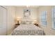 Comfortable bedroom with paisley bedding, two side tables and decorative art on the wall at 301 Ravinia Cir # 301B2, Venice, FL 34292