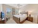 Comfortable bedroom with rattan furniture, ceiling fan, and natural light from a double window view at 301 Ravinia Cir # 301B2, Venice, FL 34292