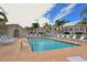 Relaxing community pool with palm trees and white lounge chairs on the brick patio at 301 Ravinia Cir # 301B2, Venice, FL 34292