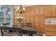 Lovely dining area featuring a black table, chandelier, and built-in wooden cabinets for storage at 301 Ravinia Cir # 301B2, Venice, FL 34292