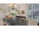 Open dining space with views into the kitchen and living room featuring an elegant chandelier above the table at 301 Ravinia Cir # 301B2, Venice, FL 34292