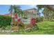 Community entrance sign nestled in lush landscaping of tropical plants and flowers at 301 Ravinia Cir # 301B2, Venice, FL 34292