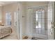 Inviting entryway with tile floors, large glass front door and open view to bedroom at 301 Ravinia Cir # 301B2, Venice, FL 34292