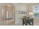 Bright foyer with neutral tones, decorative tile flooring, arched entryway, and a modern work space at 301 Ravinia Cir # 301B2, Venice, FL 34292
