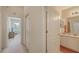 Bright hallway with access to a bedroom and a bathroom with a white vanity at 301 Ravinia Cir # 301B2, Venice, FL 34292