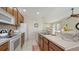 Well-equipped kitchen with stainless steel appliances and neutral countertops, flowing into the living area at 301 Ravinia Cir # 301B2, Venice, FL 34292