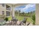 Relaxing screened lanai with seating area and views of lush landscaping and green space at 301 Ravinia Cir # 301B2, Venice, FL 34292