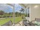 Inviting lanai featuring outdoor seating and views of a beautifully landscaped green space at 301 Ravinia Cir # 301B2, Venice, FL 34292