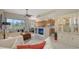 Bright living room with an open floor plan, connecting kitchen and dining area, perfect for modern living at 301 Ravinia Cir # 301B2, Venice, FL 34292