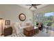 Bright living room featuring a white sofa, wood furniture, and access to a screened lanai with lovely nature views at 301 Ravinia Cir # 301B2, Venice, FL 34292