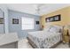 Comfortable bedroom features neutral color palette, ceiling fan, and bright natural light at 3181 E Village Dr, Venice, FL 34293