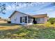 Exterior showcasing a screen room and well-maintained lawn at 3181 E Village Dr, Venice, FL 34293