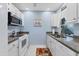 Efficient kitchen with modern appliances, granite countertops, and bright lighting at 3181 E Village Dr, Venice, FL 34293