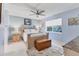 Serene main bedroom with a ceiling fan, cozy rug, and tranquil decor at 3181 E Village Dr, Venice, FL 34293