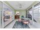 Bright sunroom featuring tile floors, neutral decor, and sliding door at 3181 E Village Dr, Venice, FL 34293