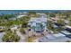 Aerial view of a waterfront home with metal roof nestled amongst palm trees and a canal nearby at 320 O Day, Englewood, FL 34223
