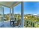 Relax on this balcony offering scenic views of lush greenery and clear blue skies at 320 O Day, Englewood, FL 34223