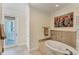 Relaxing bathroom featuring a soaking tub and door to outside balcony at 320 O Day, Englewood, FL 34223