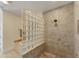 Modern bathroom with a glass-block shower wall, beige tile, and rain shower head at 320 O Day, Englewood, FL 34223