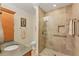 Accessible bathroom features a glass shower with handrails and beige tiling at 320 O Day, Englewood, FL 34223
