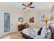 Bright bedroom featuring a ceiling fan, deck access, and plush bedding at 320 O Day, Englewood, FL 34223