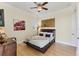 Comfortable bedroom featuring a ceiling fan and light hardwood floors at 320 O Day, Englewood, FL 34223