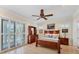 Comfortable bedroom with wood furniture, ceiling fan, and sliding doors at 320 O Day, Englewood, FL 34223