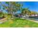 Picturesque waterfront property featuring a well-maintained lawn and a covered boat dock at 320 O Day, Englewood, FL 34223