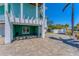 Spacious carport area with a textured tile floor, white columns and painted walls at 320 O Day, Englewood, FL 34223