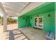 Under-house outdoor space with tile flooring and decoratively painted walls and accent pieces at 320 O Day, Englewood, FL 34223