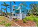 Charming two-story waterfront home featuring a crisp exterior, balconies, and a well-maintained yard at 320 O Day, Englewood, FL 34223