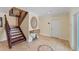 Foyer with tile flooring, staircase, round mirror over console table, and exterior door at 320 O Day, Englewood, FL 34223