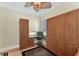 This home office features custom wood built-ins, a Murphy bed, and a ceiling fan for added comfort and convenience at 320 O Day, Englewood, FL 34223