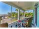 Inviting screened porch with comfortable seating and scenic views of palm trees at 320 O Day, Englewood, FL 34223
