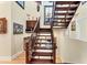 Elegant wood staircase featuring a decorative wrought iron railing at 320 O Day, Englewood, FL 34223