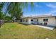 Inviting backyard featuring a lush lawn, hot tub, and ample space for relaxation and entertainment at 3355 Roslyn Rd, Venice, FL 34293