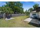 Spacious backyard with a lush lawn, hot tub, and mature trees, offering a serene outdoor oasis at 3355 Roslyn Rd, Venice, FL 34293