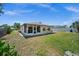 Spacious backyard with a well-kept lawn and an enclosed lanai, offering a perfect blend of indoor-outdoor living at 3355 Roslyn Rd, Venice, FL 34293