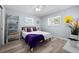 A cozy bedroom with a ceiling fan, two windows, and decorative wall art at 3355 Roslyn Rd, Venice, FL 34293