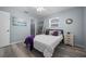 Bright bedroom with modern gray flooring, ceiling fan, and stylish decor accents create a cozy retreat at 3355 Roslyn Rd, Venice, FL 34293