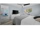 A soothing bedroom with blue walls featuring a ceiling fan and dresser with a television at 3355 Roslyn Rd, Venice, FL 34293