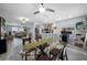 Open-concept dining area features wood-look floors, a glass-top table, and seamless flow to the kitchen at 3355 Roslyn Rd, Venice, FL 34293