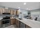 Bright kitchen featuring wood cabinetry, stainless steel appliances and a marble countertop at 3355 Roslyn Rd, Venice, FL 34293